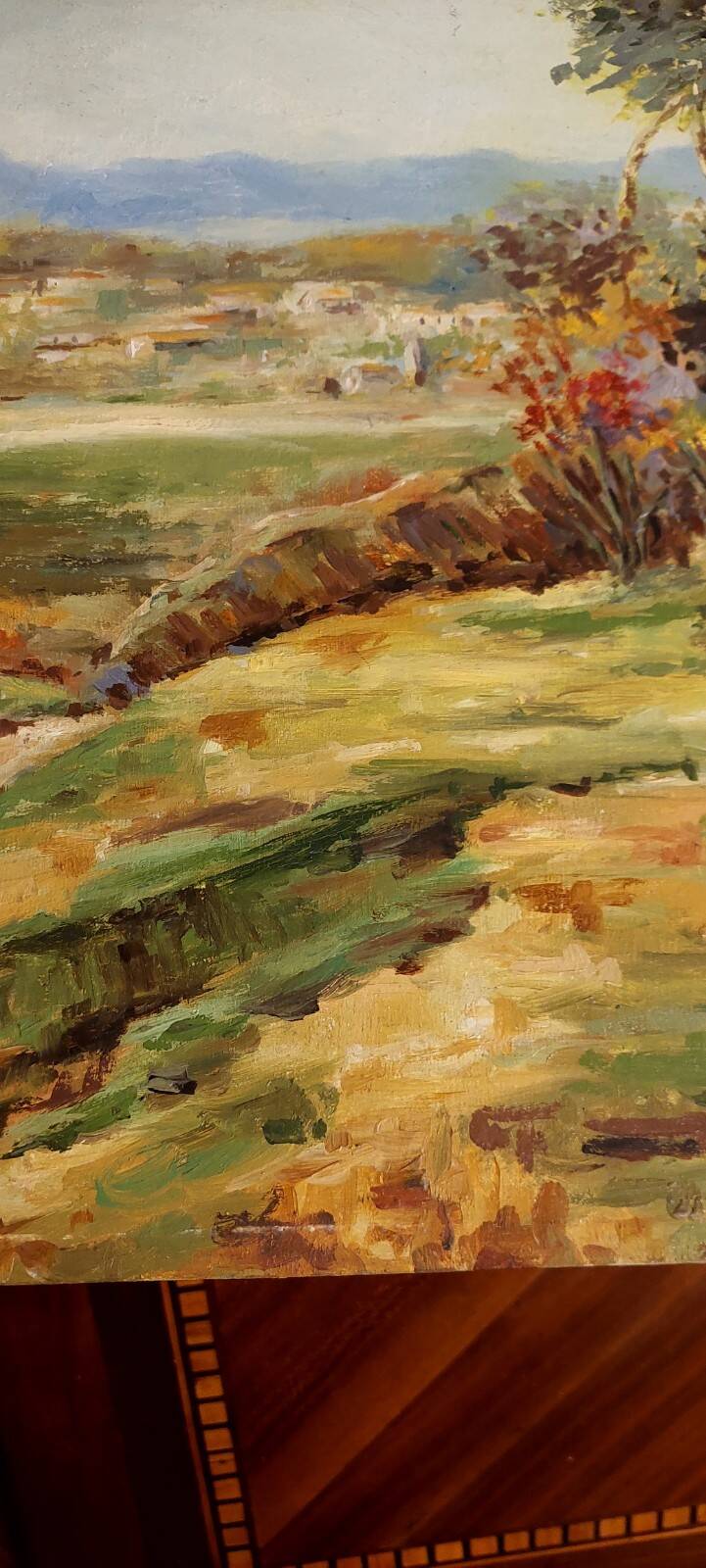 Oil painting on panel of a rural landscape, signed.