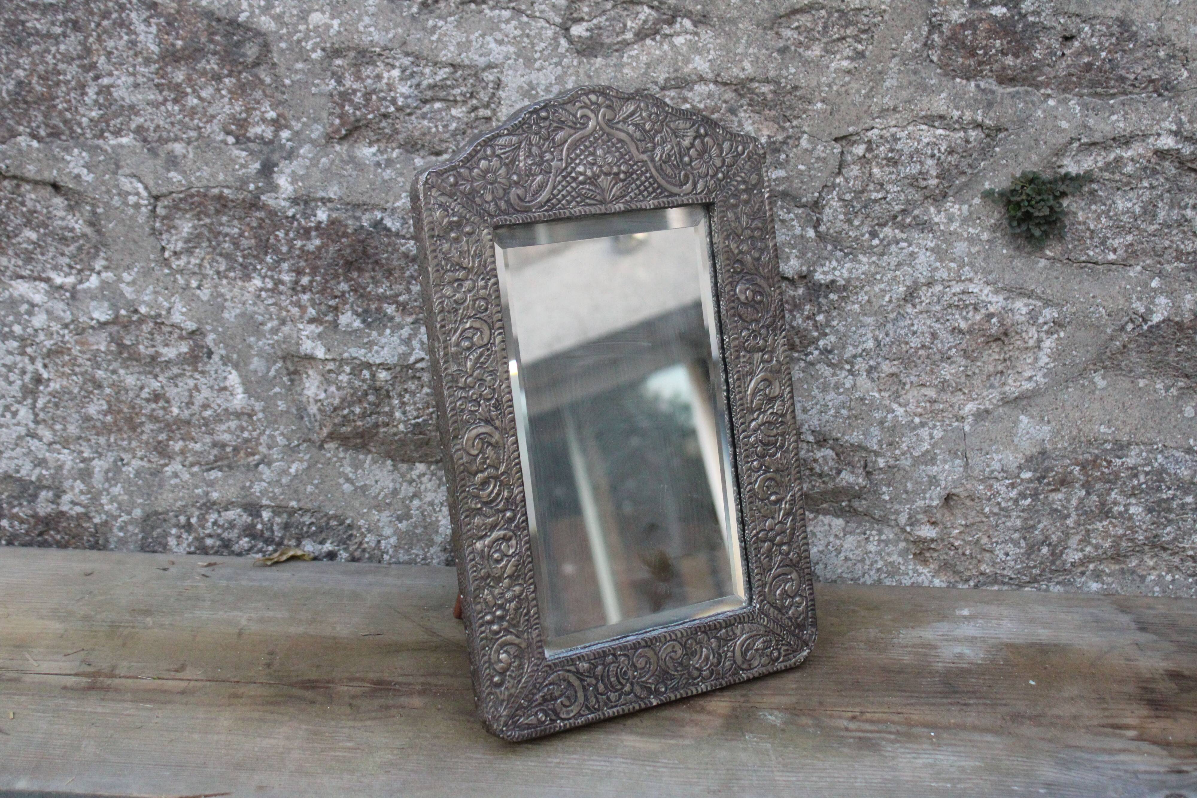 Oriental mirror in chiseled metal – beveled, for placing on a surface or hanging