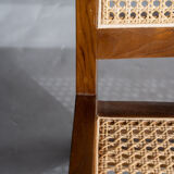 Reclined armchair in canned teak in natural wood