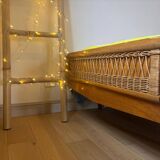 Vintage single bed made of rattan from the 1970s with a mattress.