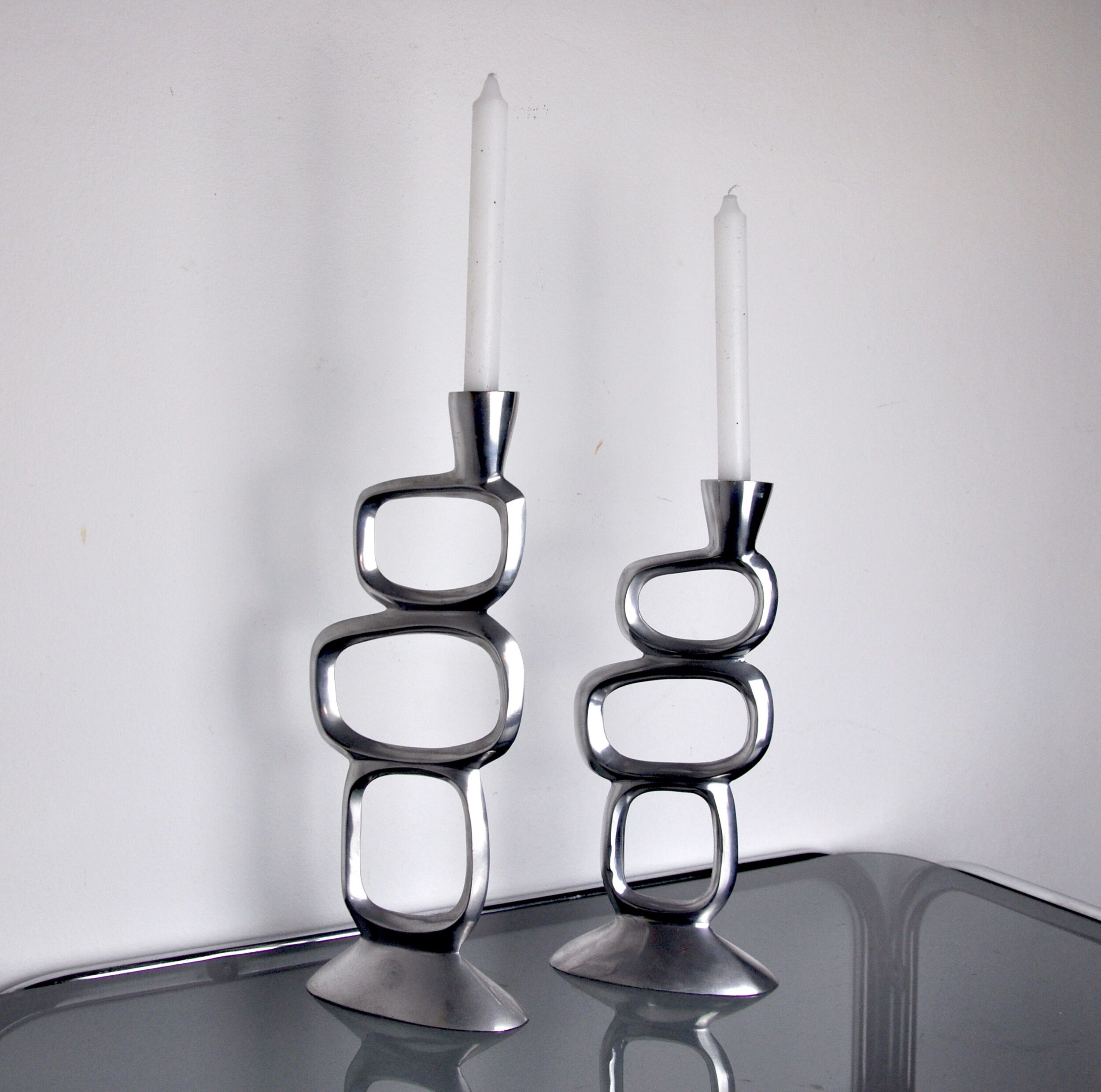 Pair of circle candlesticks by matthew hilton, england, 1980