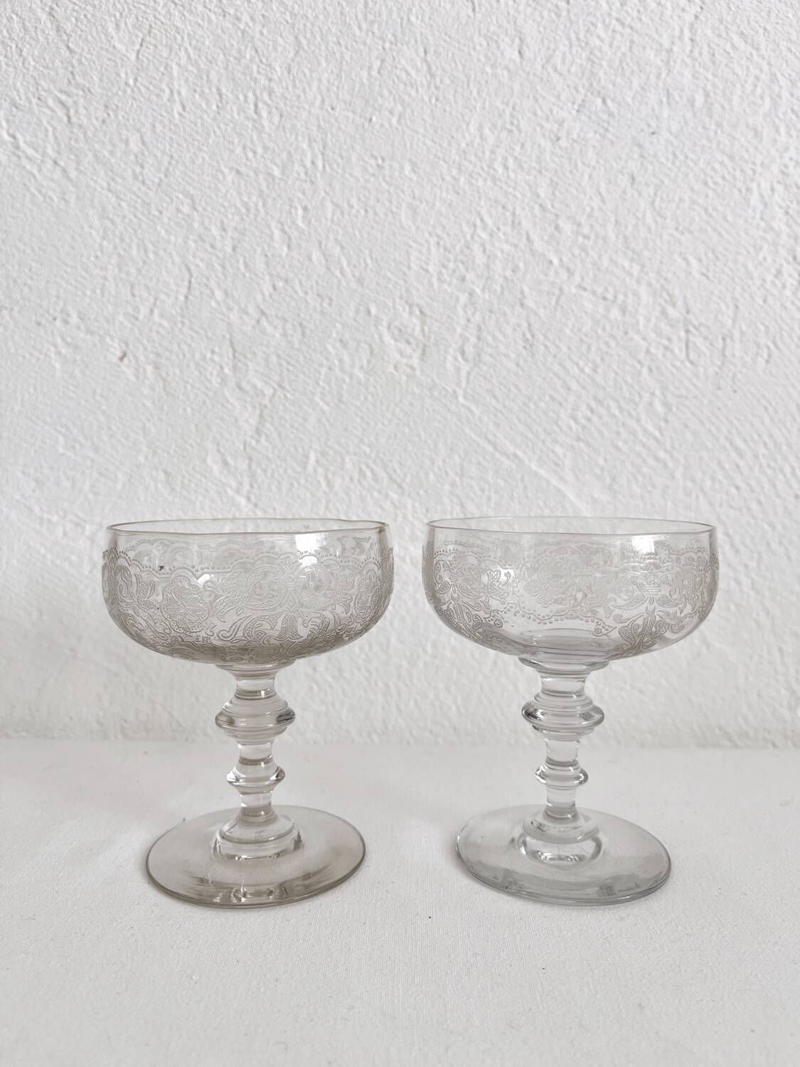 2 antique champagne glasses in engraved glass