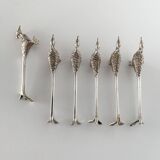 Six silver-plated knife rests in the shape of peacocks.