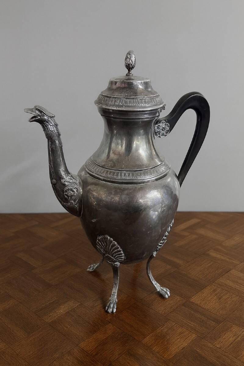 Empire style silver-plated verseuse, resting on three sculpted feet.