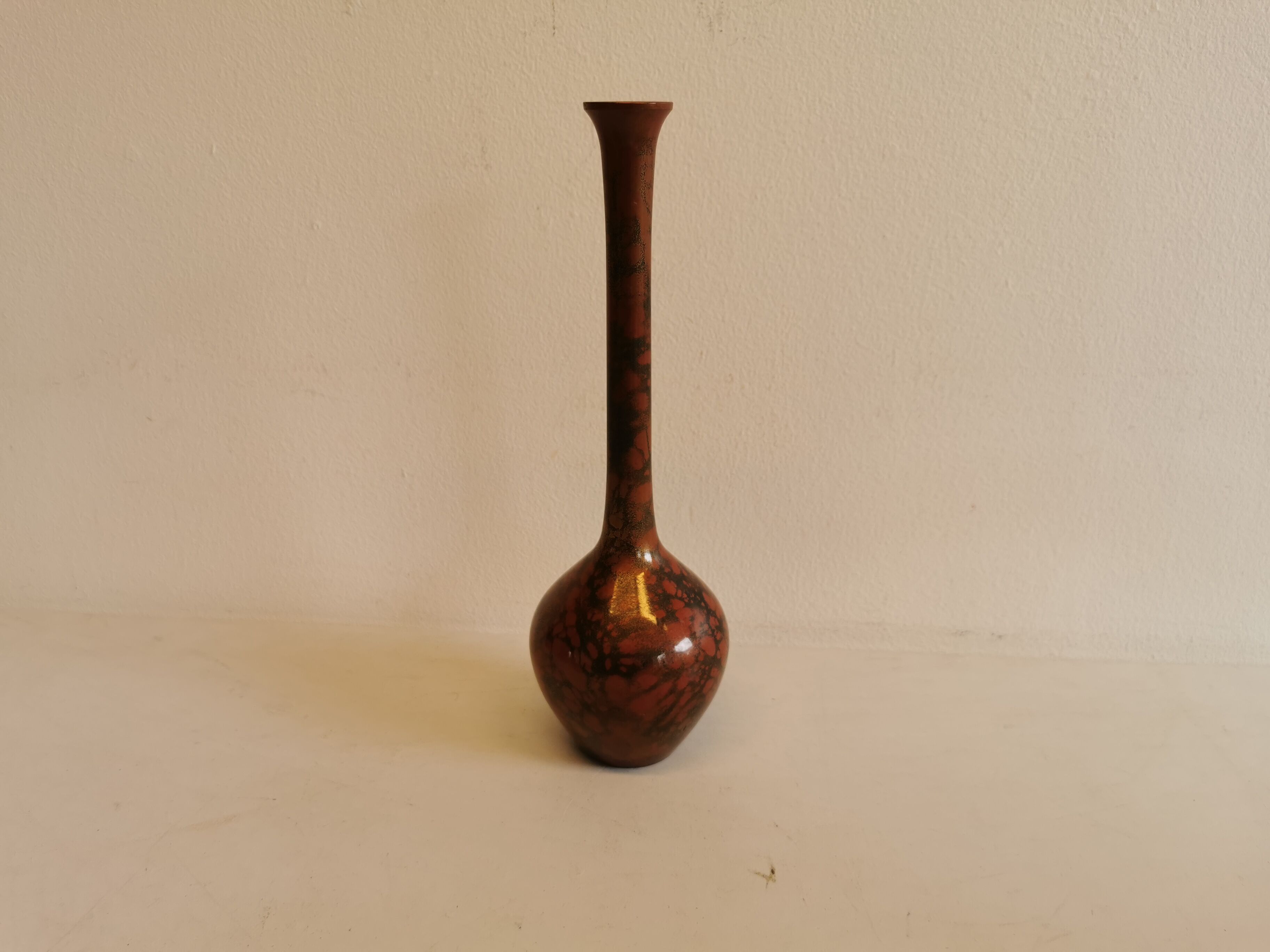 Slim vase with metallic finish.