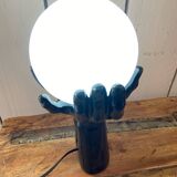 Lamp hands holding a globe