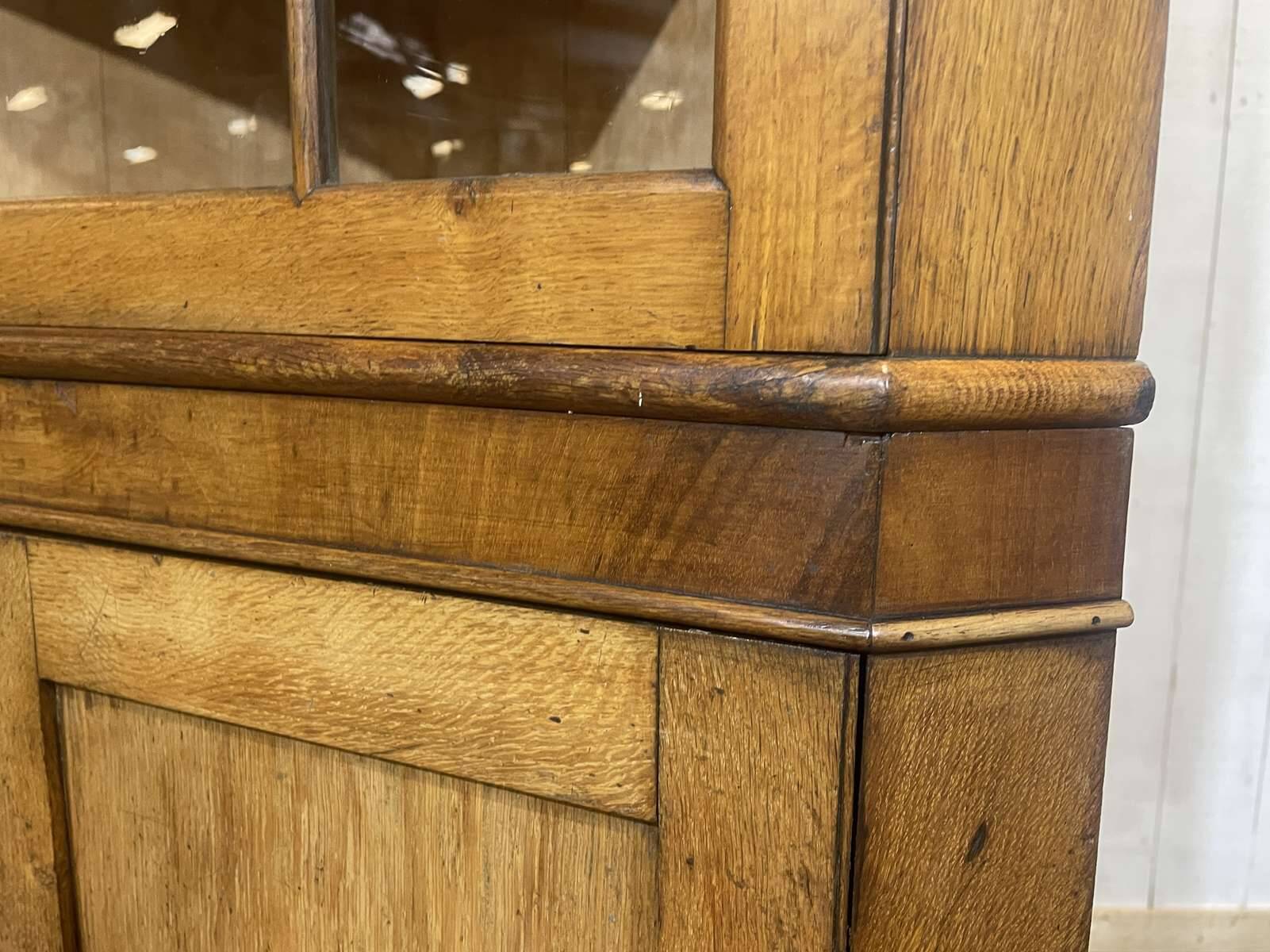 19th-century English corner cabinet in oak, mahogany, and fir.