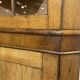 19th-century English corner cabinet in oak, mahogany, and fir.