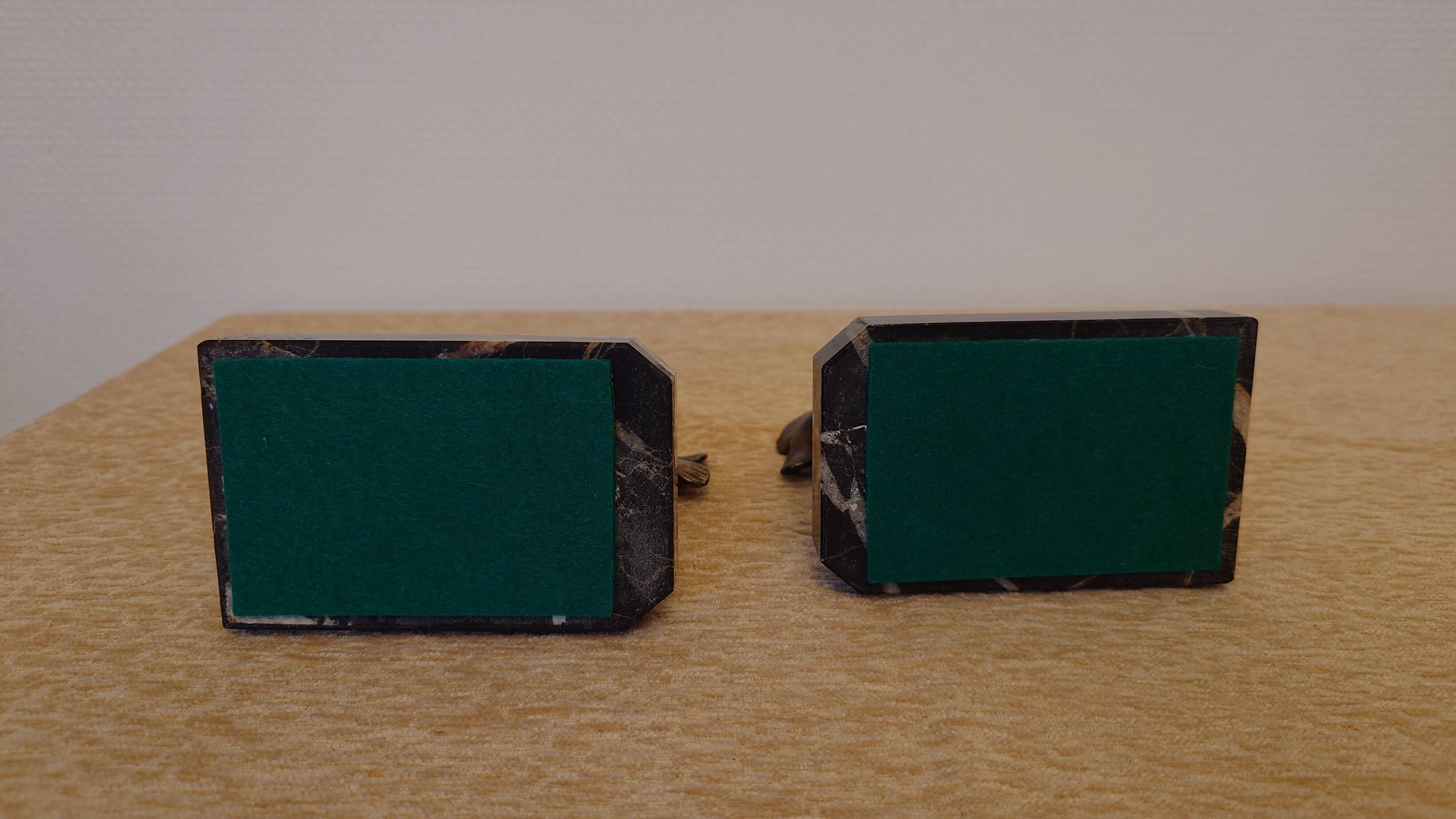 Art Deco pair of bookends with stylised fish in patinated metal and marble.