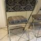 Two antique Manufrance folding chairs in metal and fabric