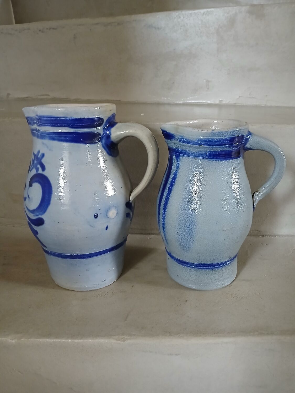 2 antique stoneware pitchers