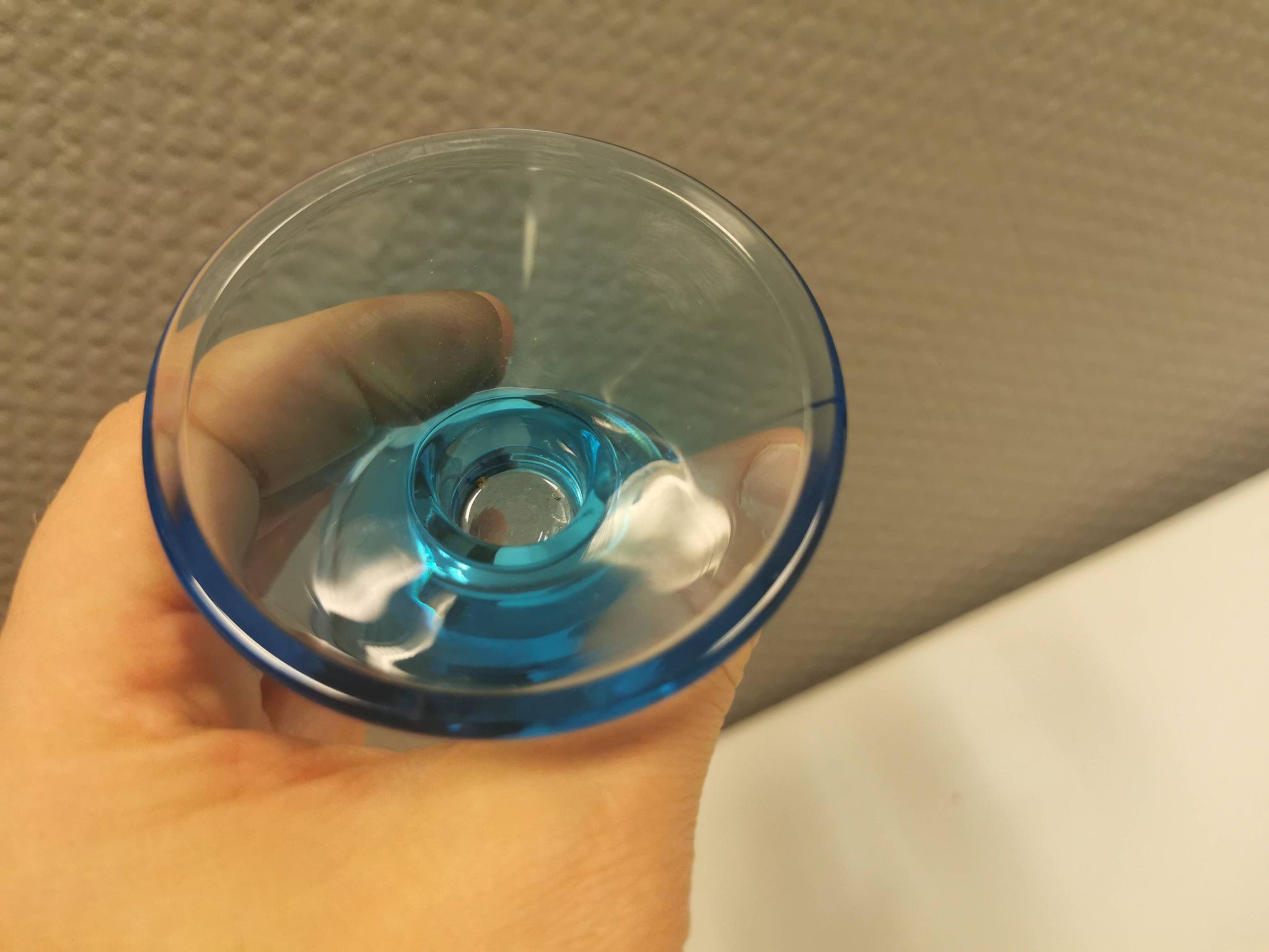 Two small candle holders in blue glass from the well-known Finnish company Ittala.