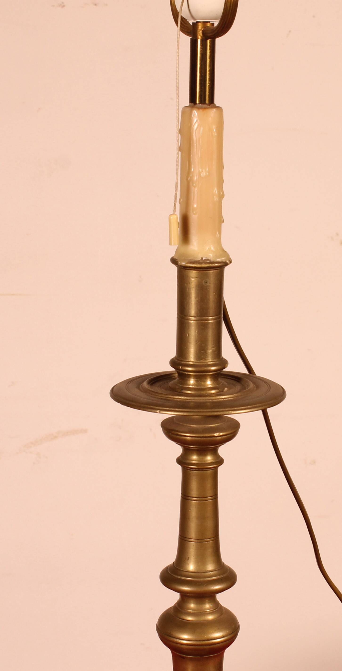 bronze candlestick from the 17th century converted into a lamp with its lampshade