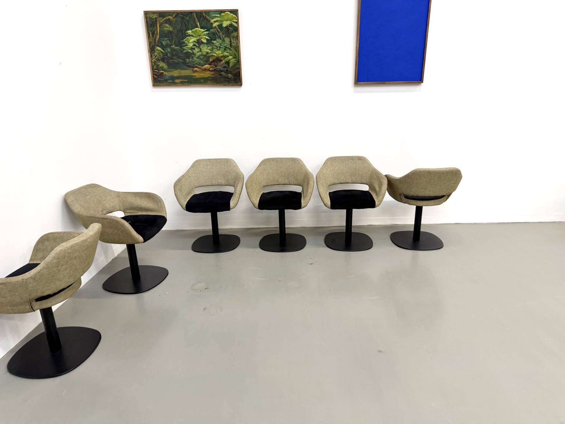 Series of six swivel chairs with an organic shell, patterned fabric and base.