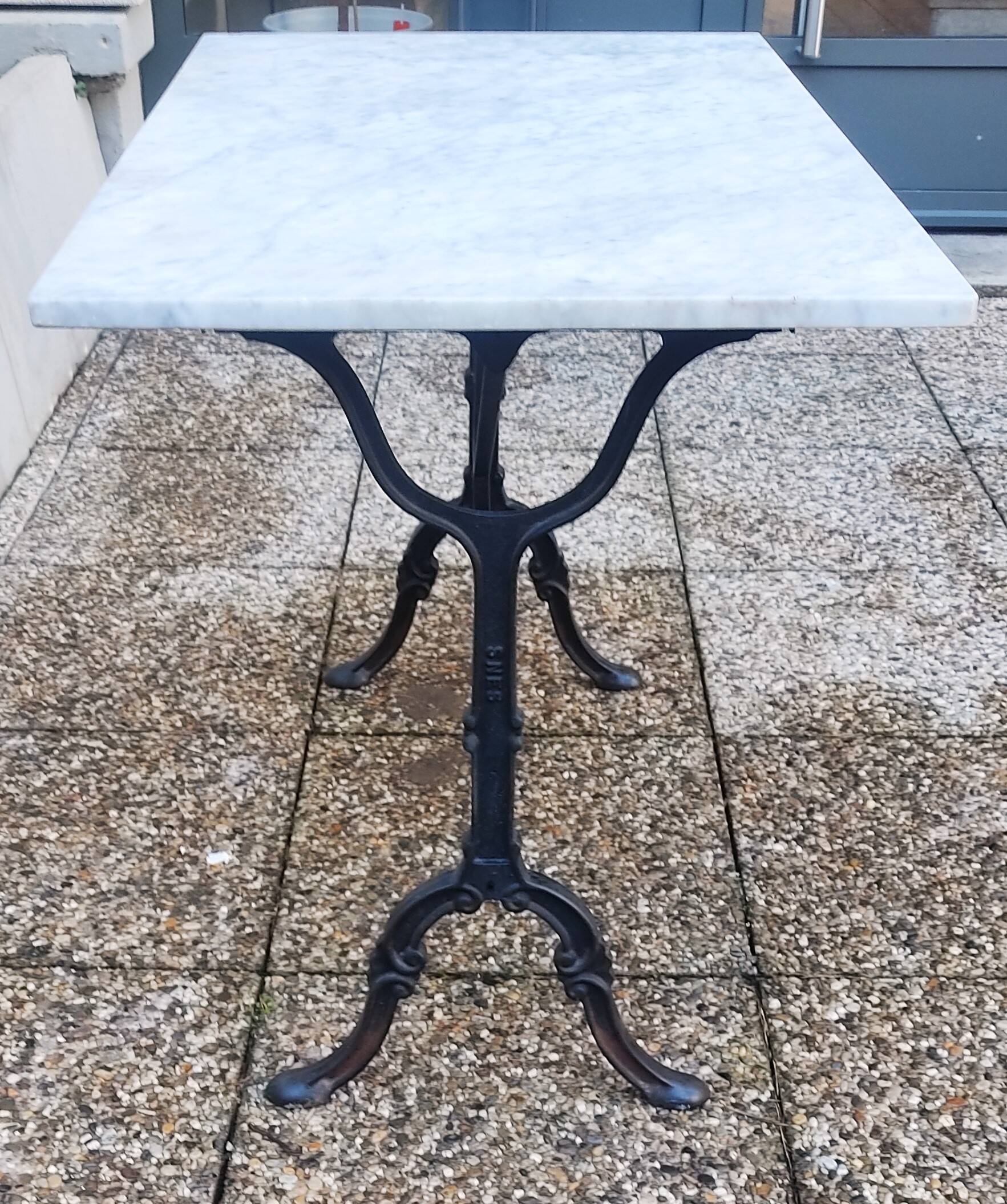 White marble table, cast iron base signed SNES, made in France