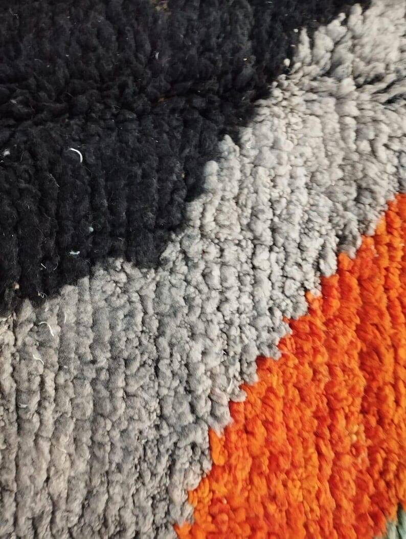 Large handmade Moroccan rug with colourful patterns.