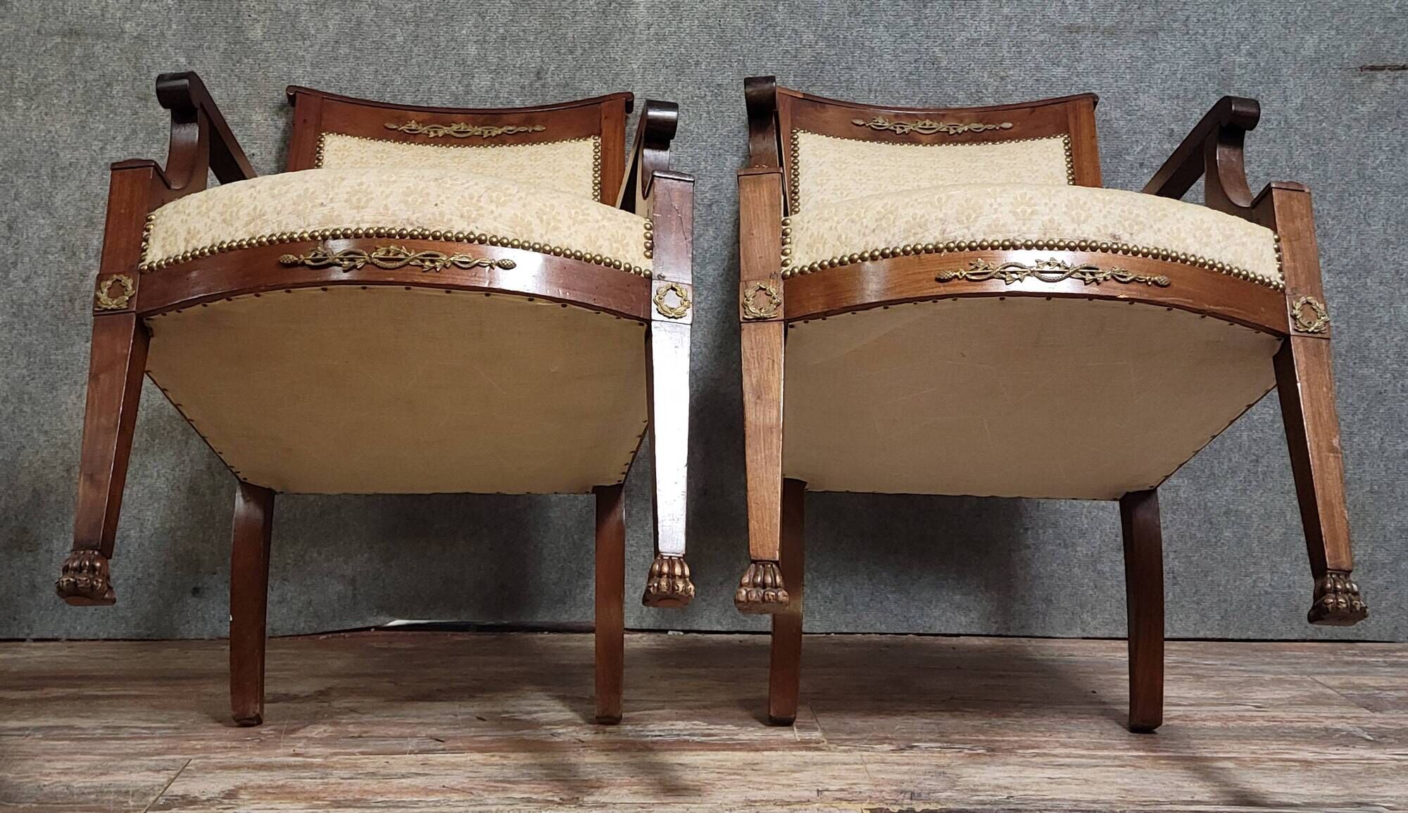 Pair of Empire period armchairs, in mahogany and gilded bronze.