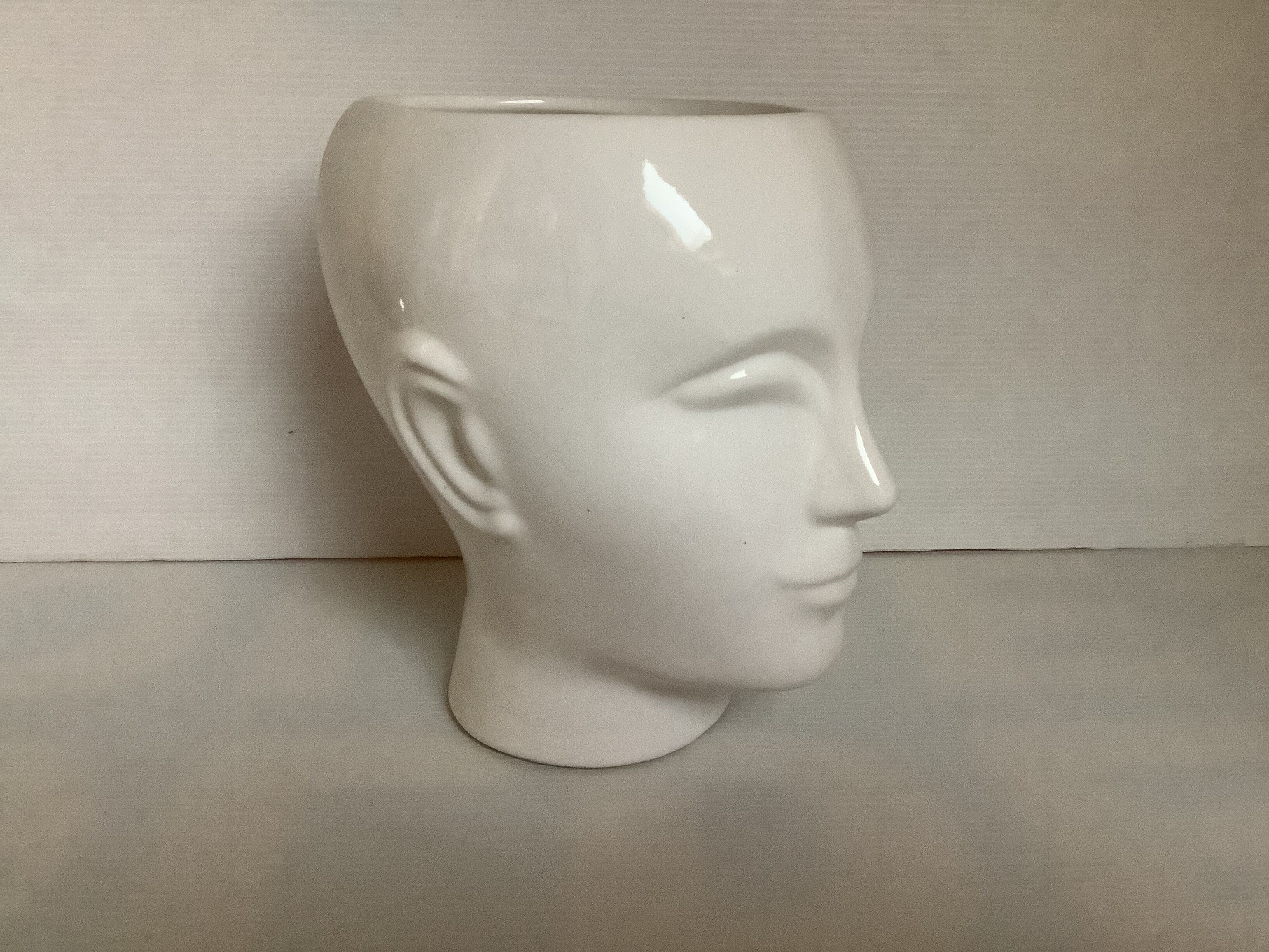 Man's head hide pot vase