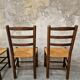 4 wooden and straw chairs