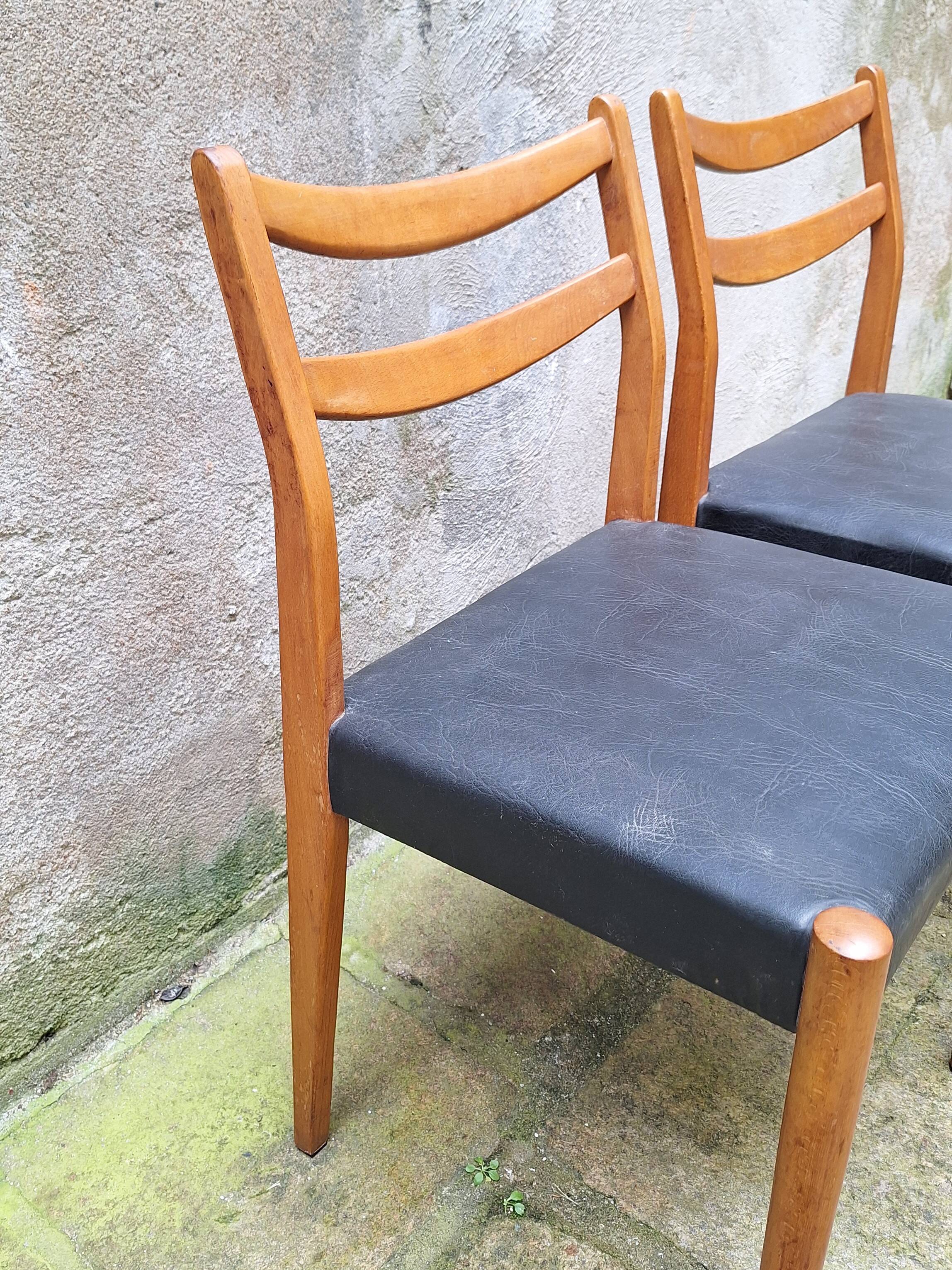 Pair of Scandinavian style chairs in wood and faux leather.