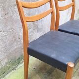 Pair of Scandinavian style chairs in wood and faux leather.