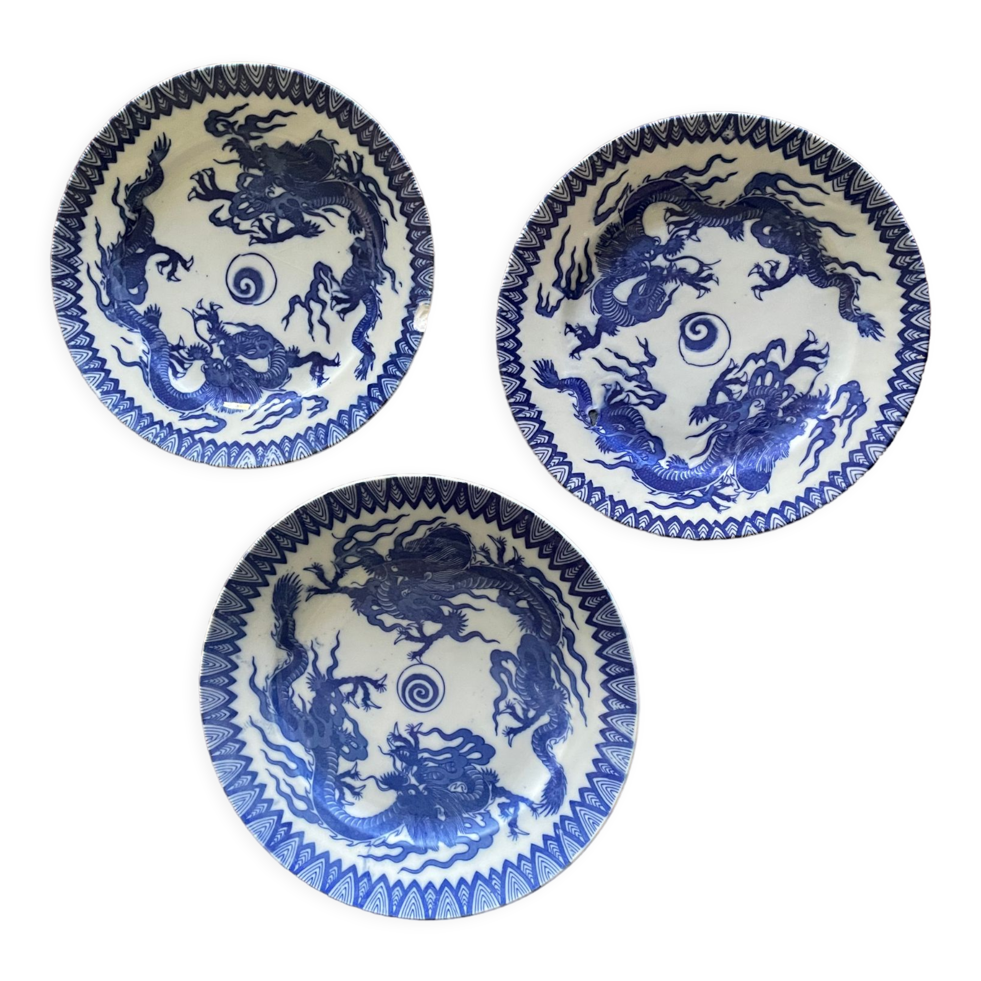 Asian porcelain plates decorated with blue dragons