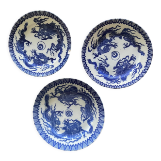 Asian porcelain plates decorated with blue dragons