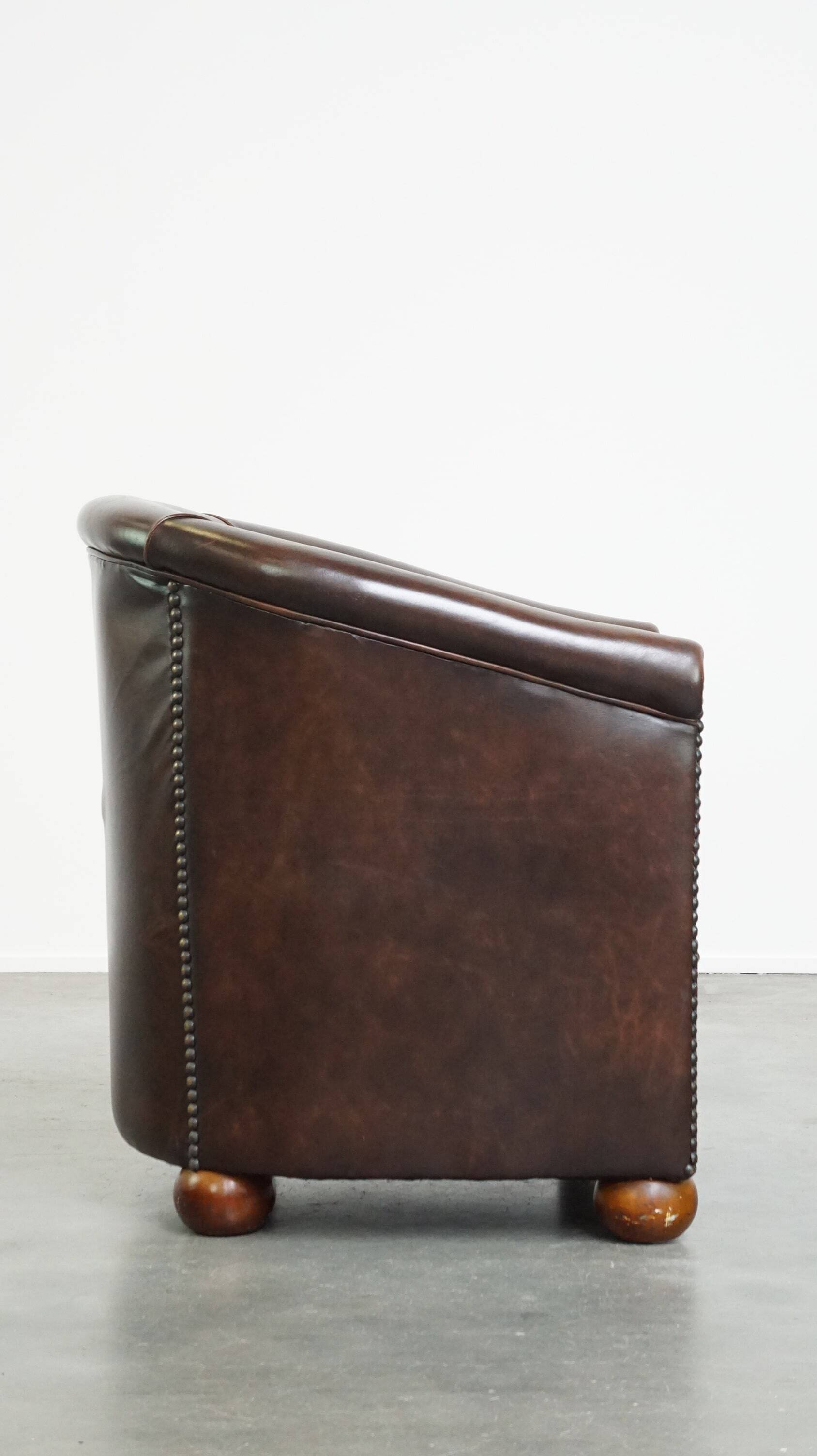 luxury dark leather club chair with English-style ball feet