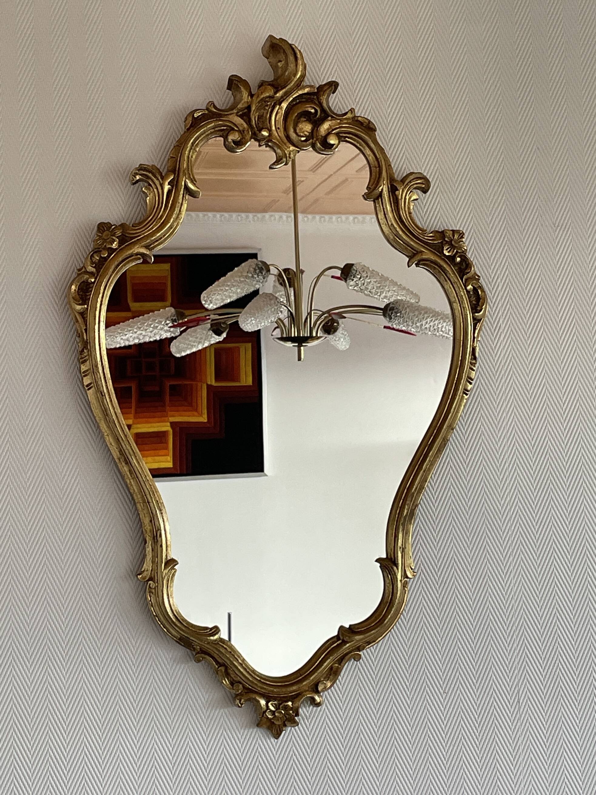 Old baroque style wall mirror with golden moldings