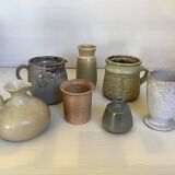 Seven beige and gray ceramic vases