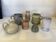 Seven beige and gray ceramic vases