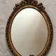 Miroir ovale en bois doré 52 x 35 cm