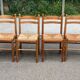4 solid wood kitchen chairs with straw seats in a country farmhouse style.