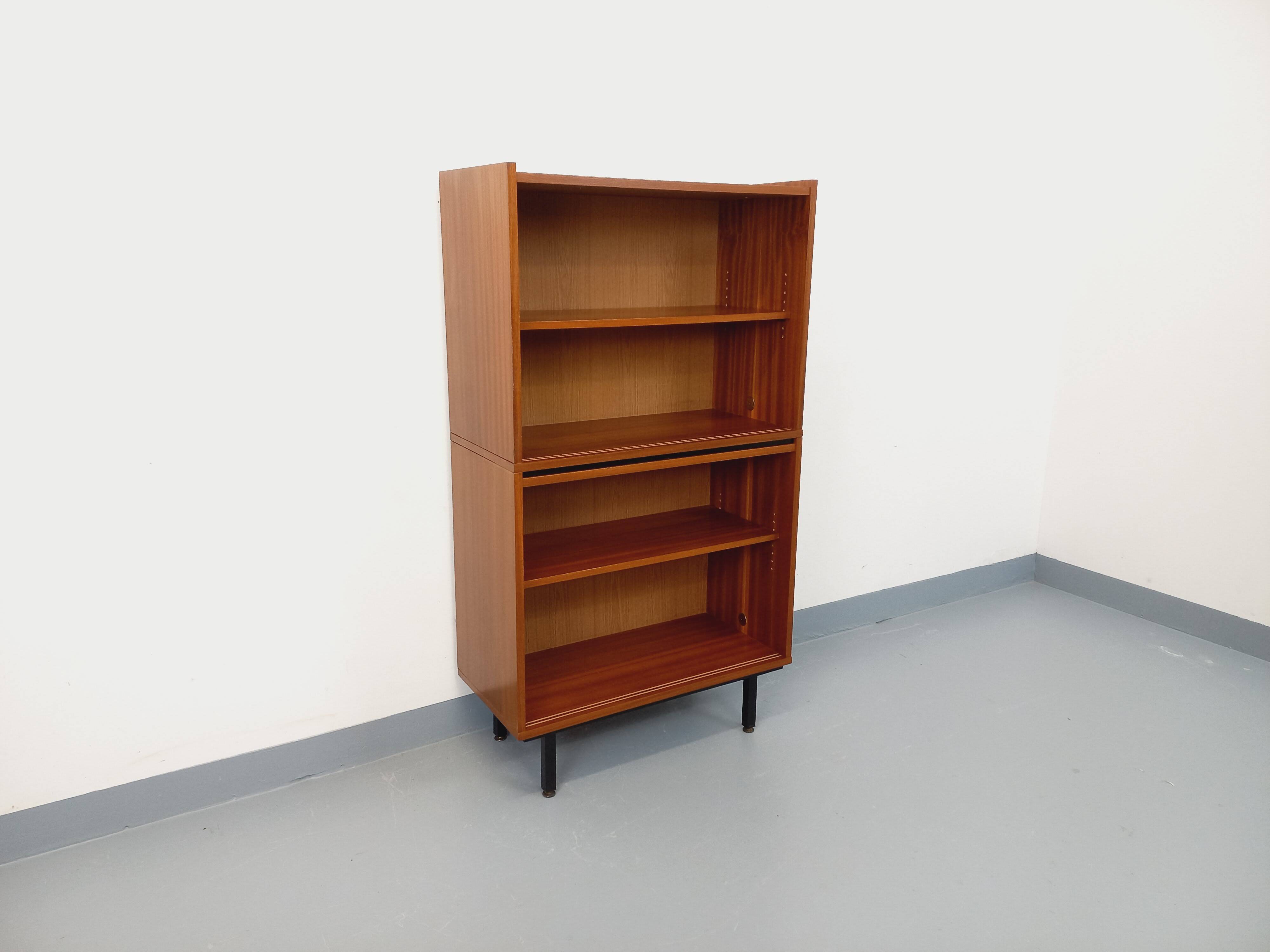 Vintage wooden bookshelf in teak style from the 1960s.