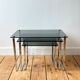 Nest of coffee tables in chrome with smoked glass top.