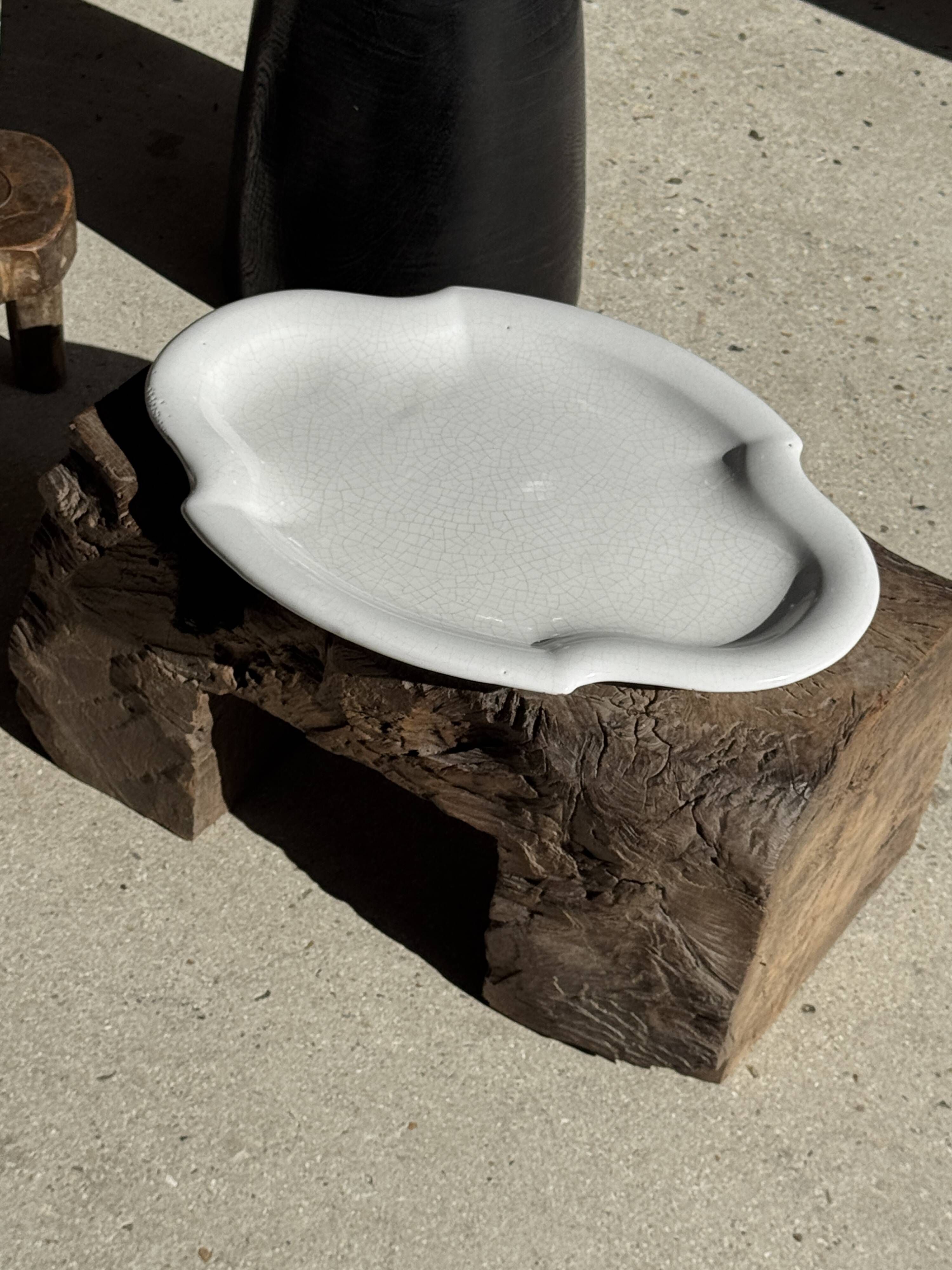 Antique oval-shaped white crackled faience plate with a scalloped edge.