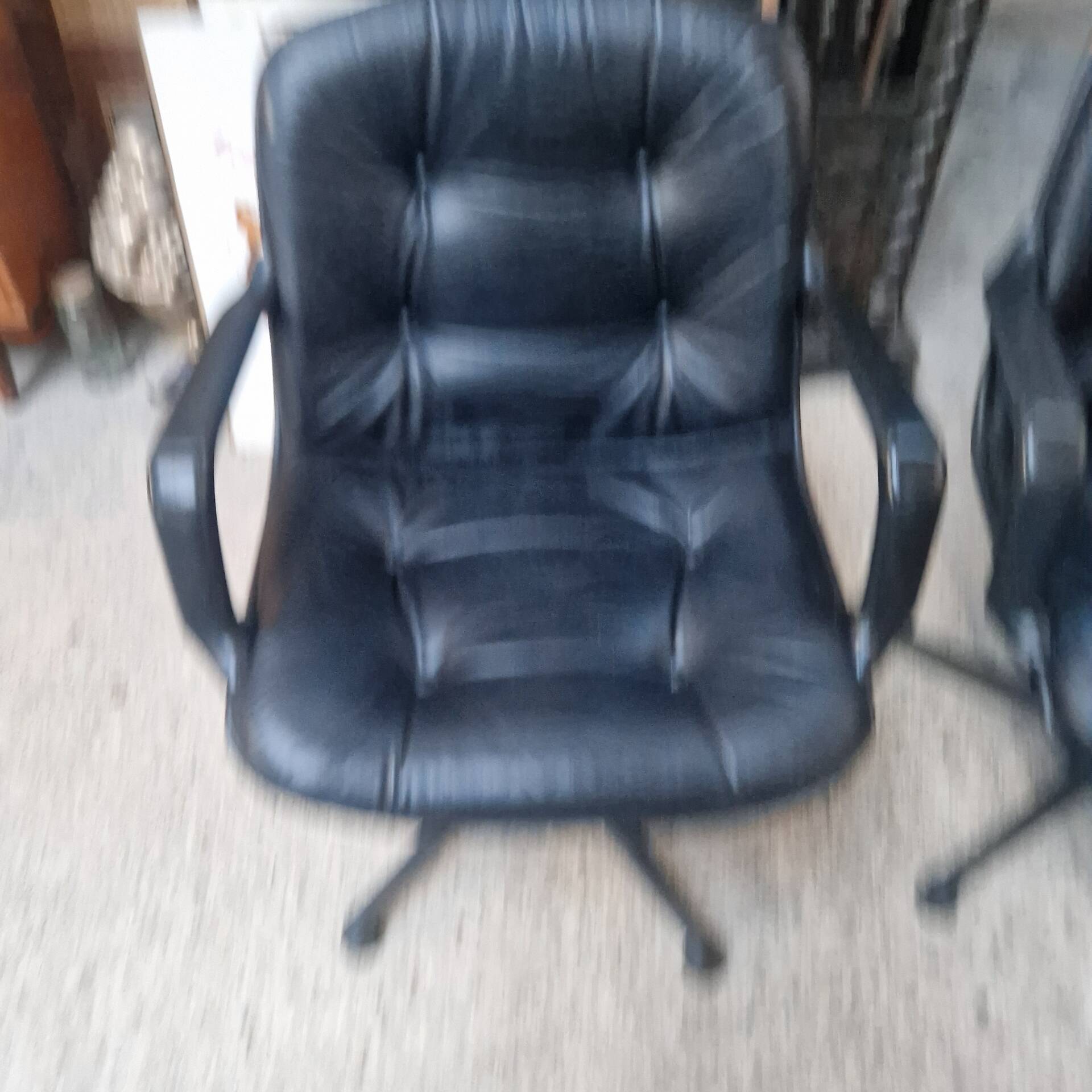 Pair of Comforto armchairs in black leather. Vintage 70s.