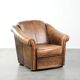 Fauteuil en peau de mouton magnifiquement conçu et confortable, avec un look intemporel et une finition de passepoil assortie.