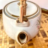 Vintage teapot in stoneware handle in rattan