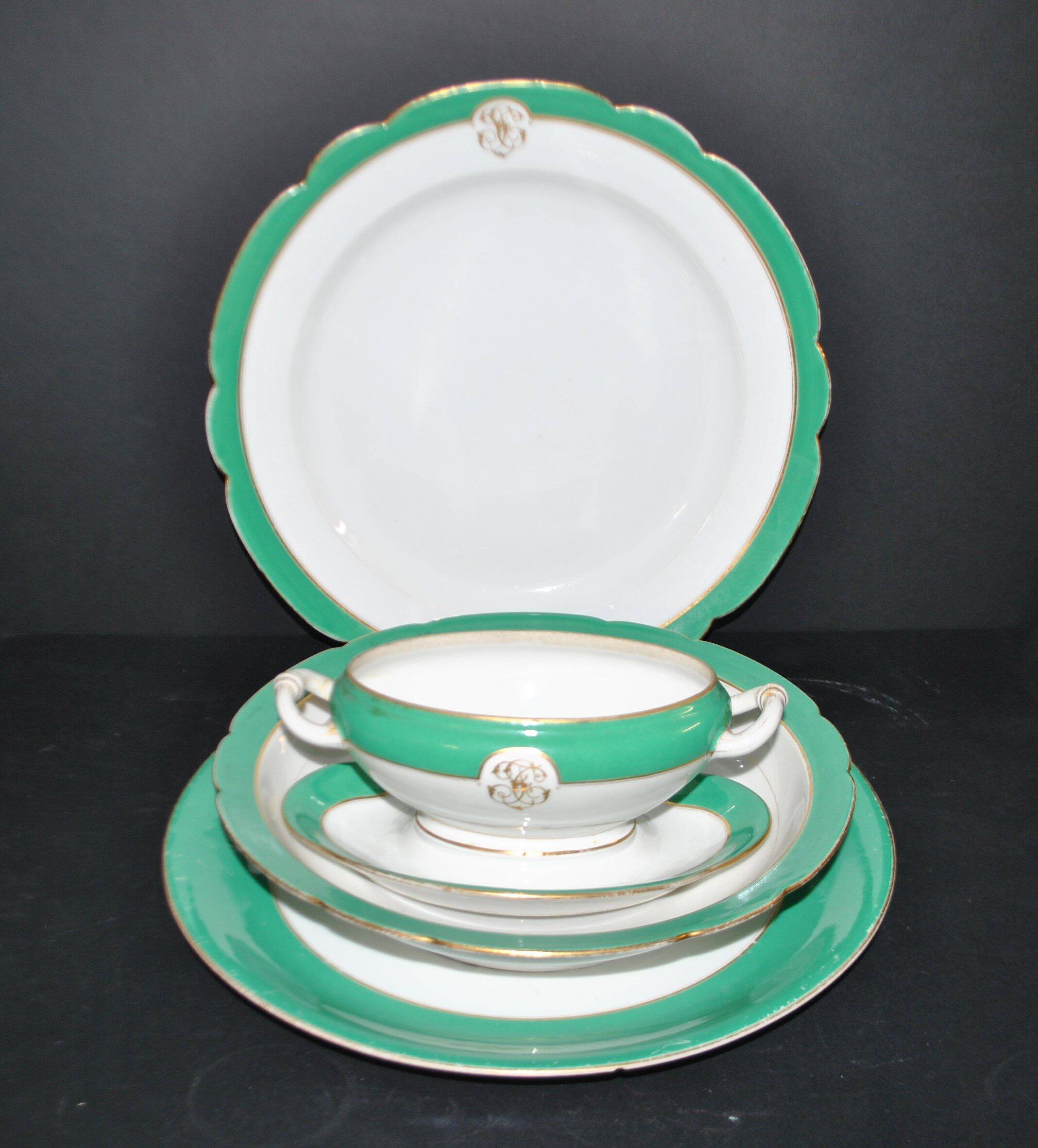 Paris porcelain set of 3 plates and a sauce boat with green border and gold monogram JC.