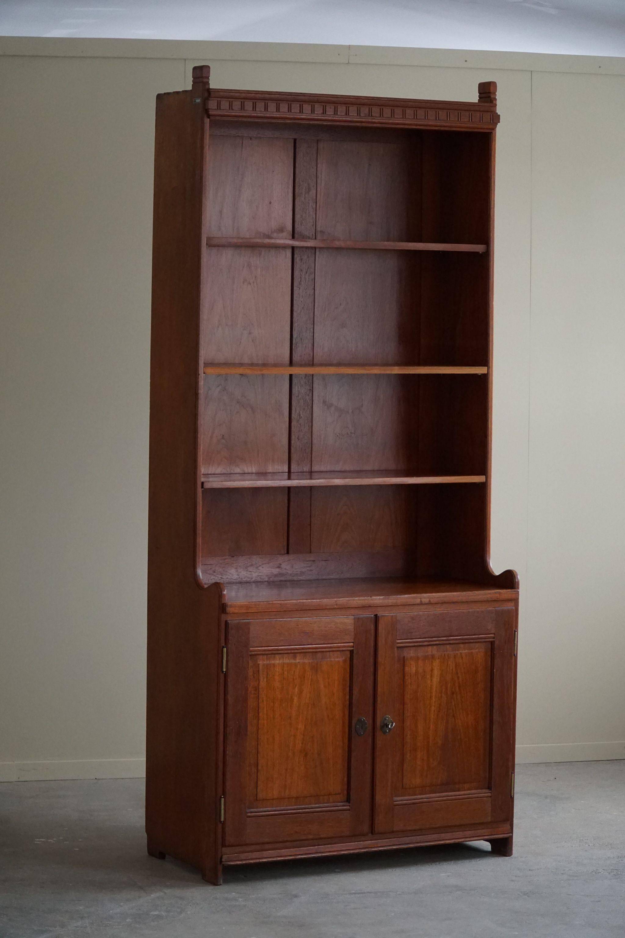 Rare high cabinet in teak by Martin Nyrop for Rud. Rasmussen, Denmark, early 20th century.