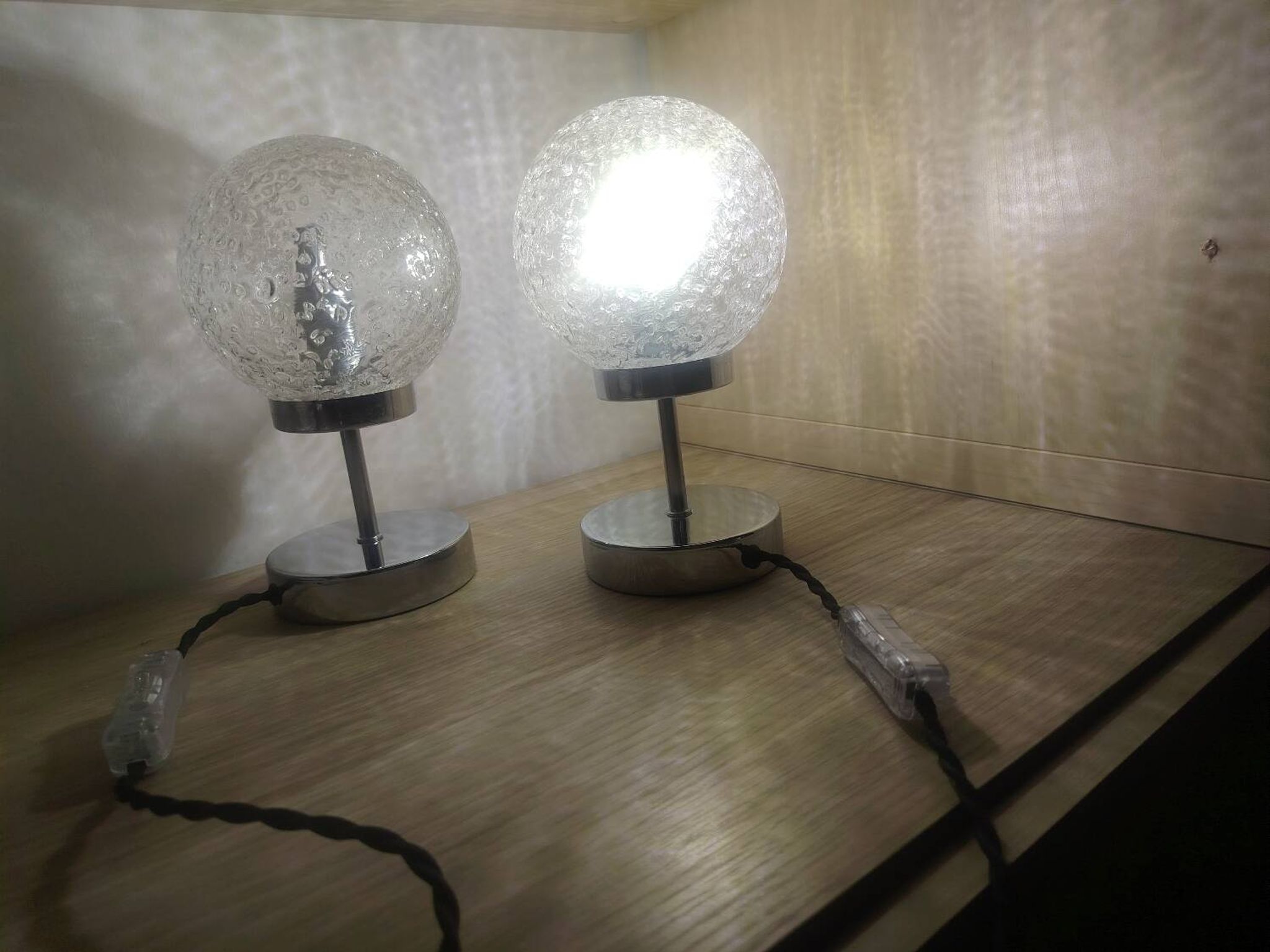 Duo of textured globe lamps with a large play of light.