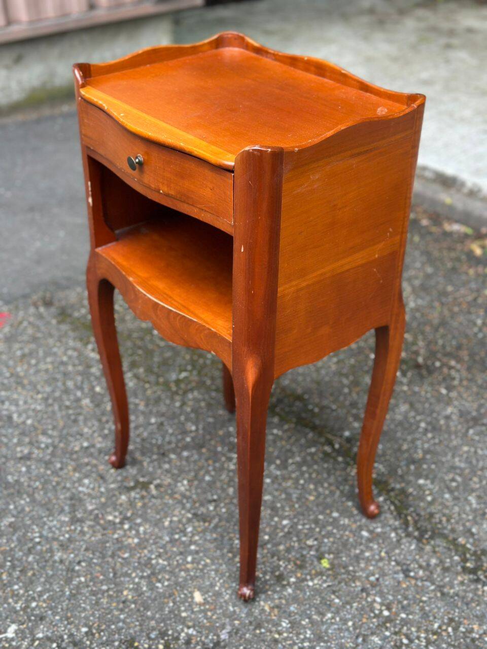 2 bedside tables in transitional or Louis XV style, made of curved solid wood with drawers.