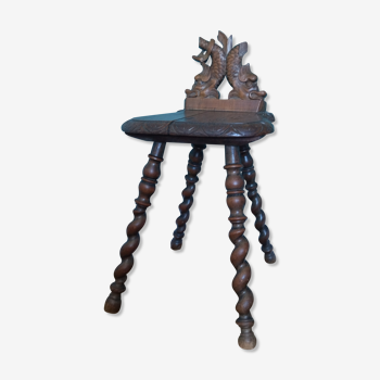 Antique stool in carved wood