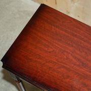 Small console with two drawers in hardwood finish.