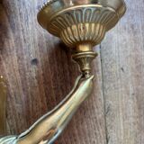 Pair of bronze wall sconces with outstretched arms and hands