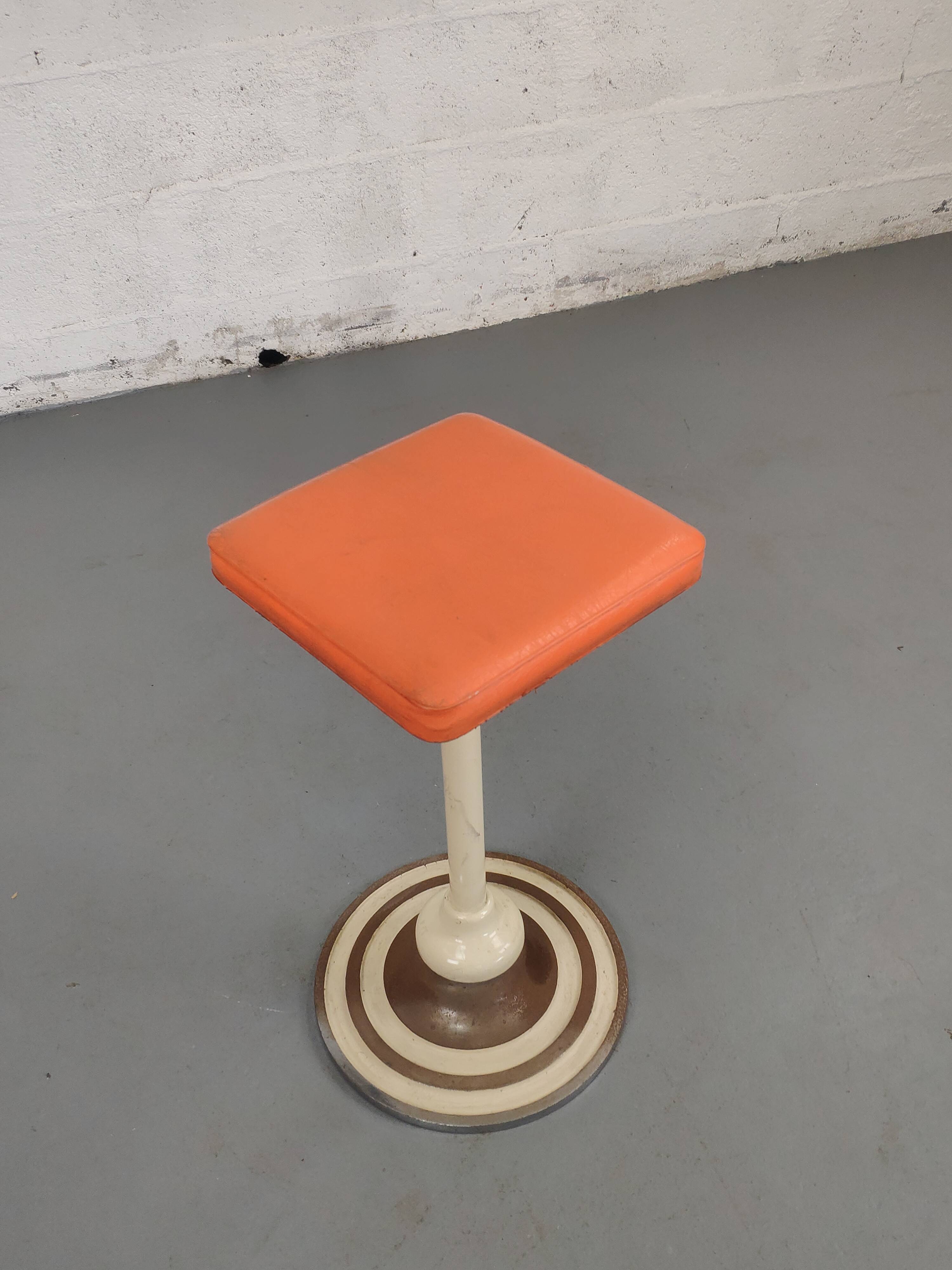 Old swivel orange sitting dentist stool