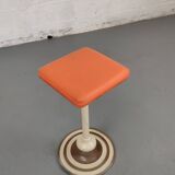 Old swivel orange sitting dentist stool