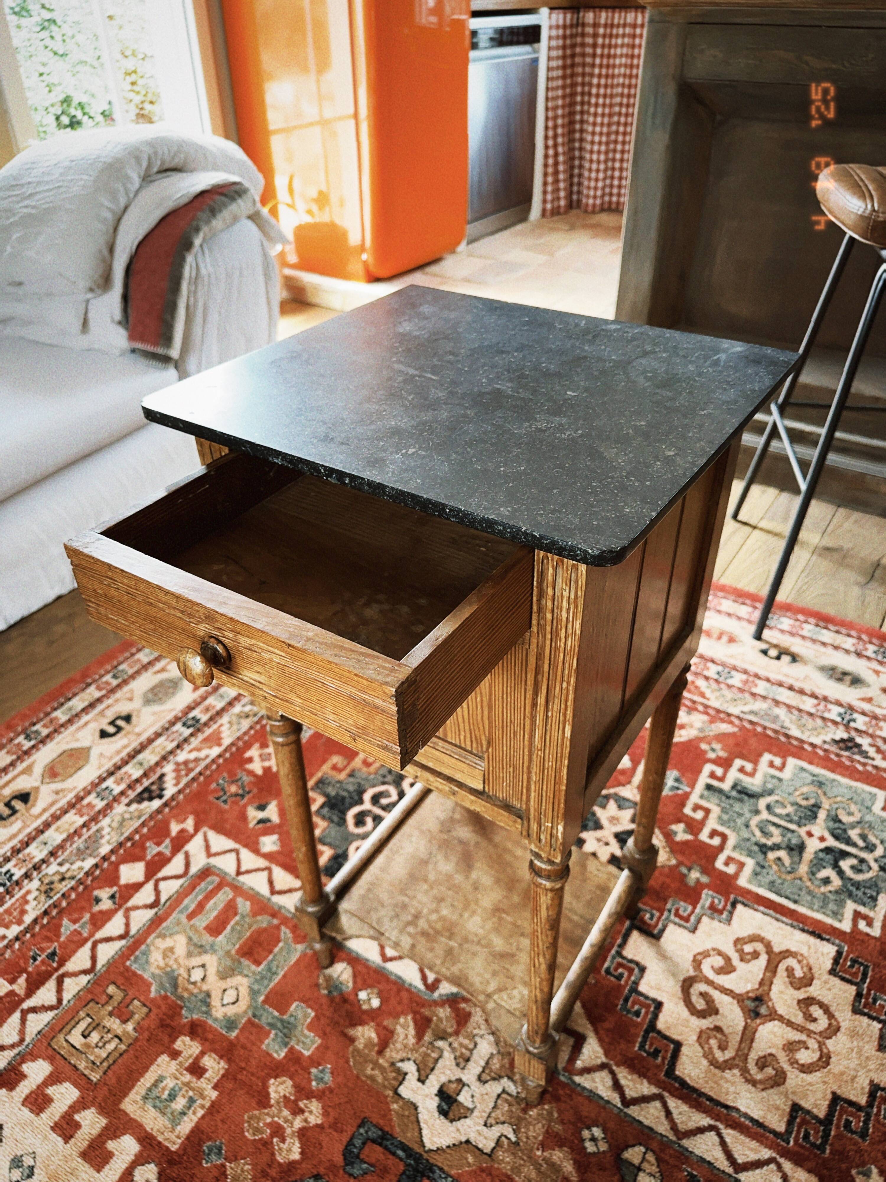 Antique wooden bedside table with marble top