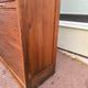 Vintage 1940s secretary desk with wooden curtains, storage, and shutters.